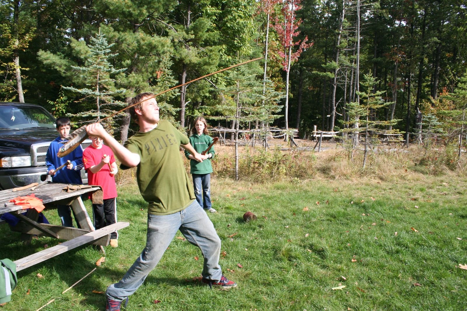 Children trying hands-on activities outdoors during a school visit