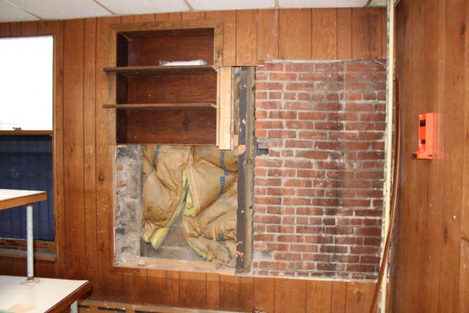 Exposed east wall in the basement office used for inmate processing.