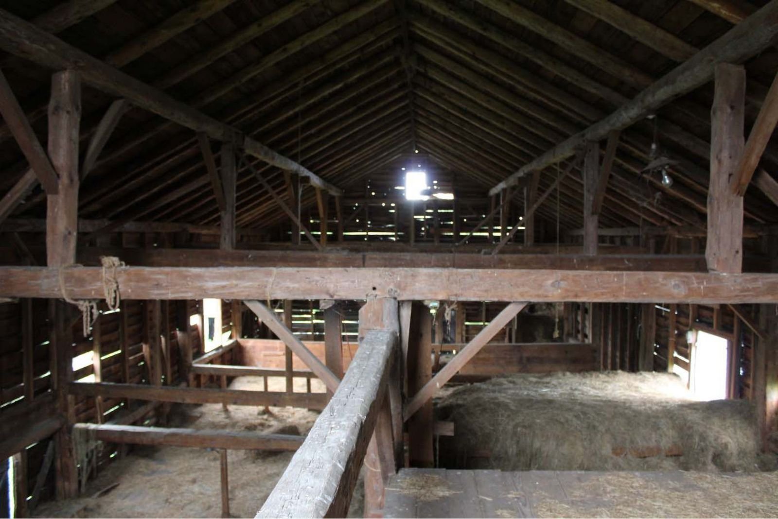 Hand-hewn queen truss framing inside a c.1800 barn